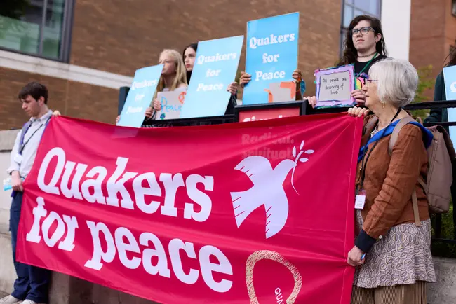 A group of Quakers holding signs saying Quakers for Peace